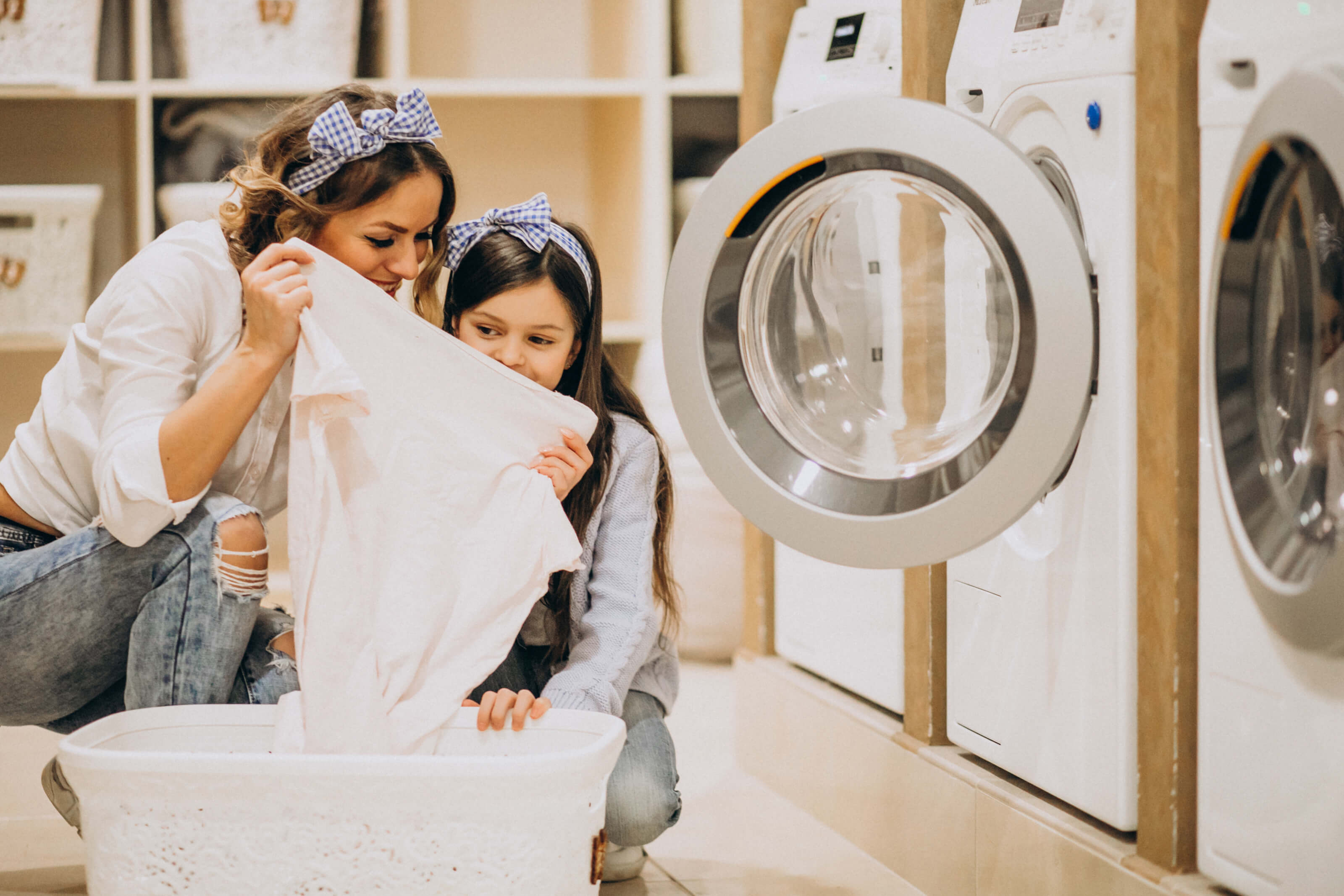 mother-with-daughter-doing-laundry-self-serviece-laundrette